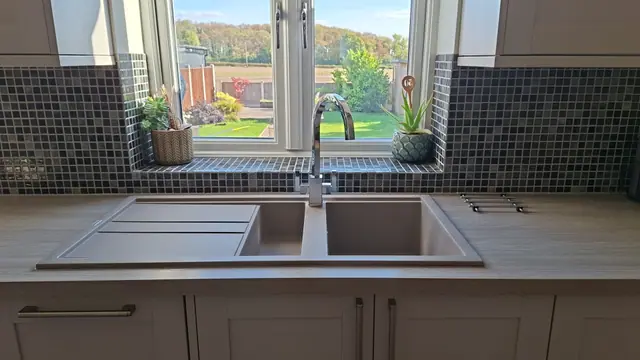Finished kitchen sink with mosaic splashback and tiled window sill