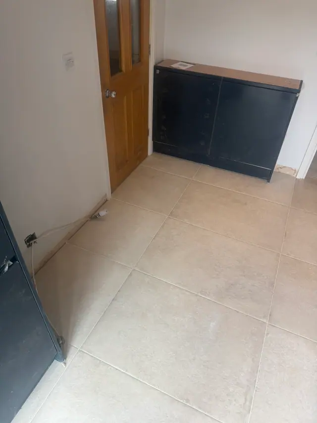 Large-format floor tiling laid across a renovated interior