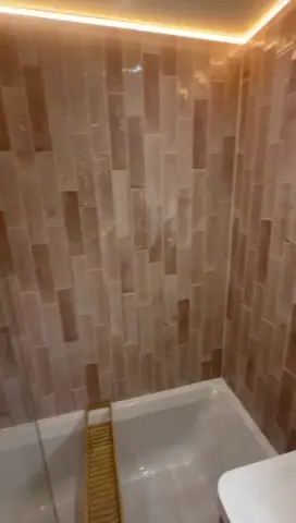 Video tour of a warm pink tiled bathroom